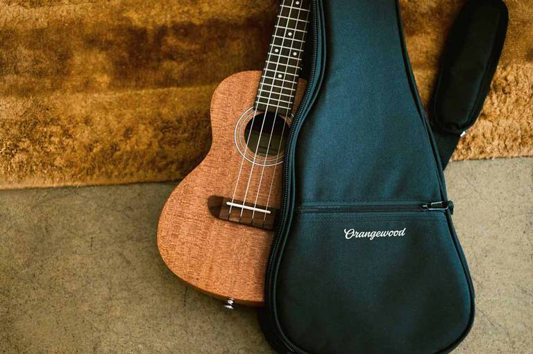 Milo concert mahogany ukulele inside an orangewood branded gig bag