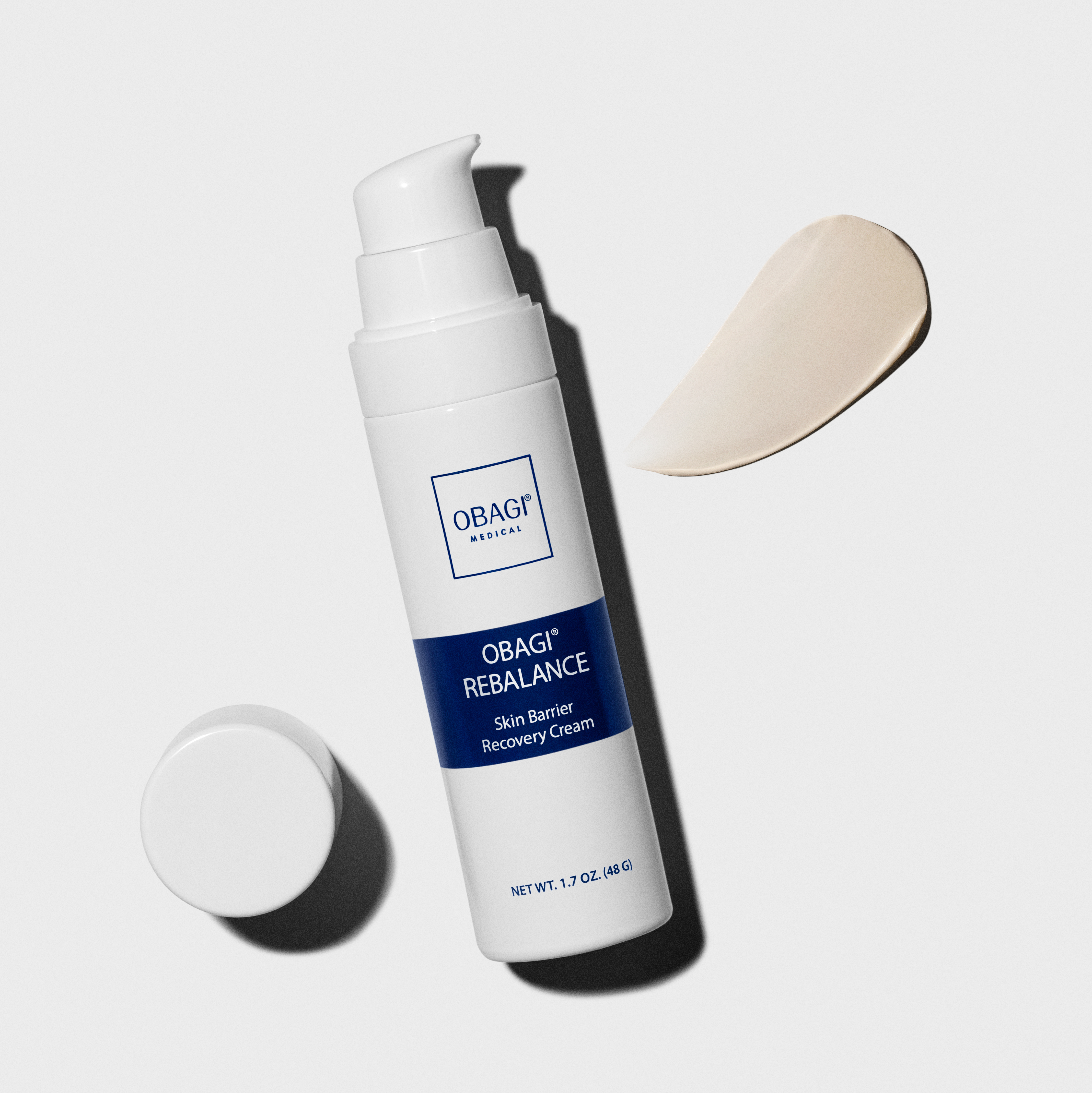 Obagi Rebalance Skin Barrier Recovery Cream bottle placed on a minimalist surface with soft shadows.